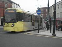 An inbound tram crosses Drake Street in Rochdale on the first day of service into the Town Centre.  J Dillon
